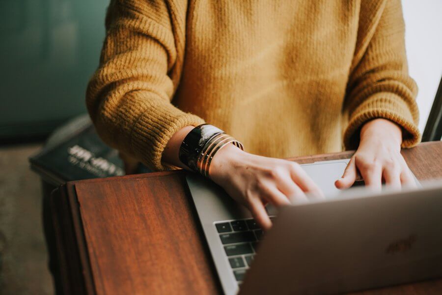 Blogger writing on a laptop at home