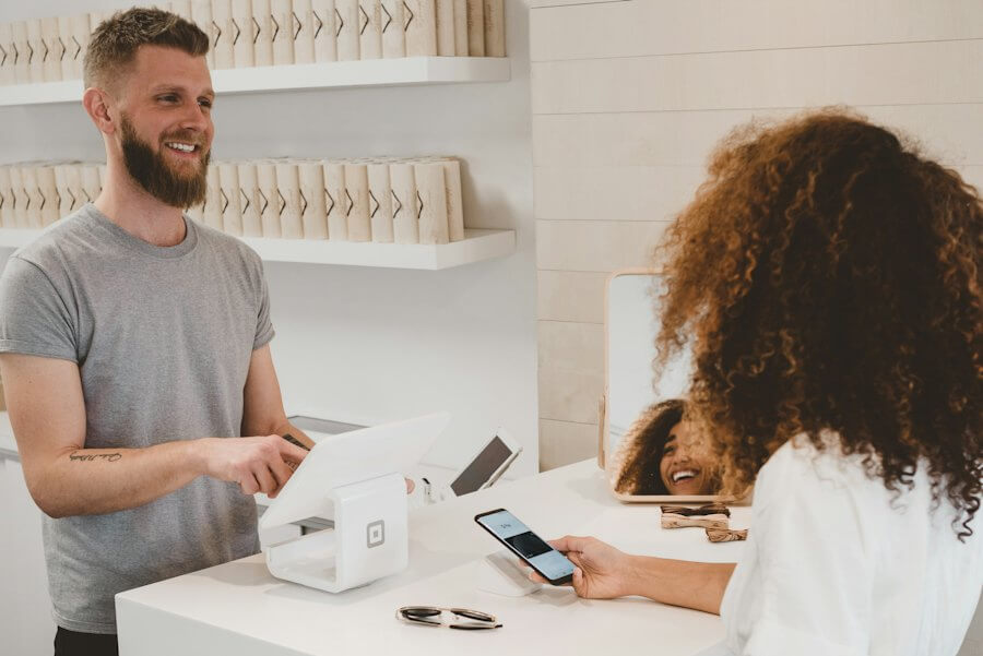 Store owner taking a card payment at the counter